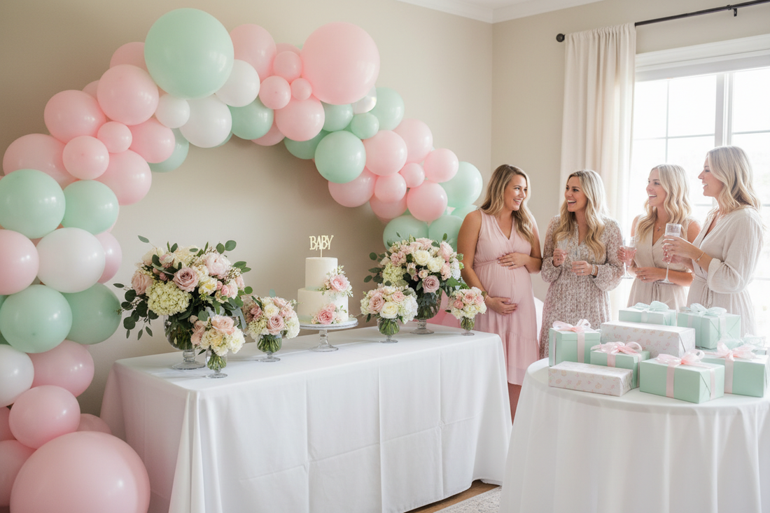 Baby shower decoration flat lay with pink and blue balloons, floral centerpiece, baby items, and party supplies on pastel background